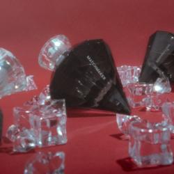 Frasco de Black Diamond entre cubitos de hielo sobre fondo rojo