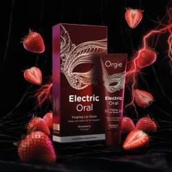 Orgie Electric Oral con su caja, rodeado de fresas sobre fondo oscuro