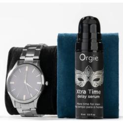 Envase Orgie Xtra Time sérum junto a un reloj de pulsera decorativo