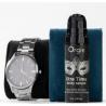 Envase Orgie Xtra Time sérum junto a un reloj de pulsera decorativo